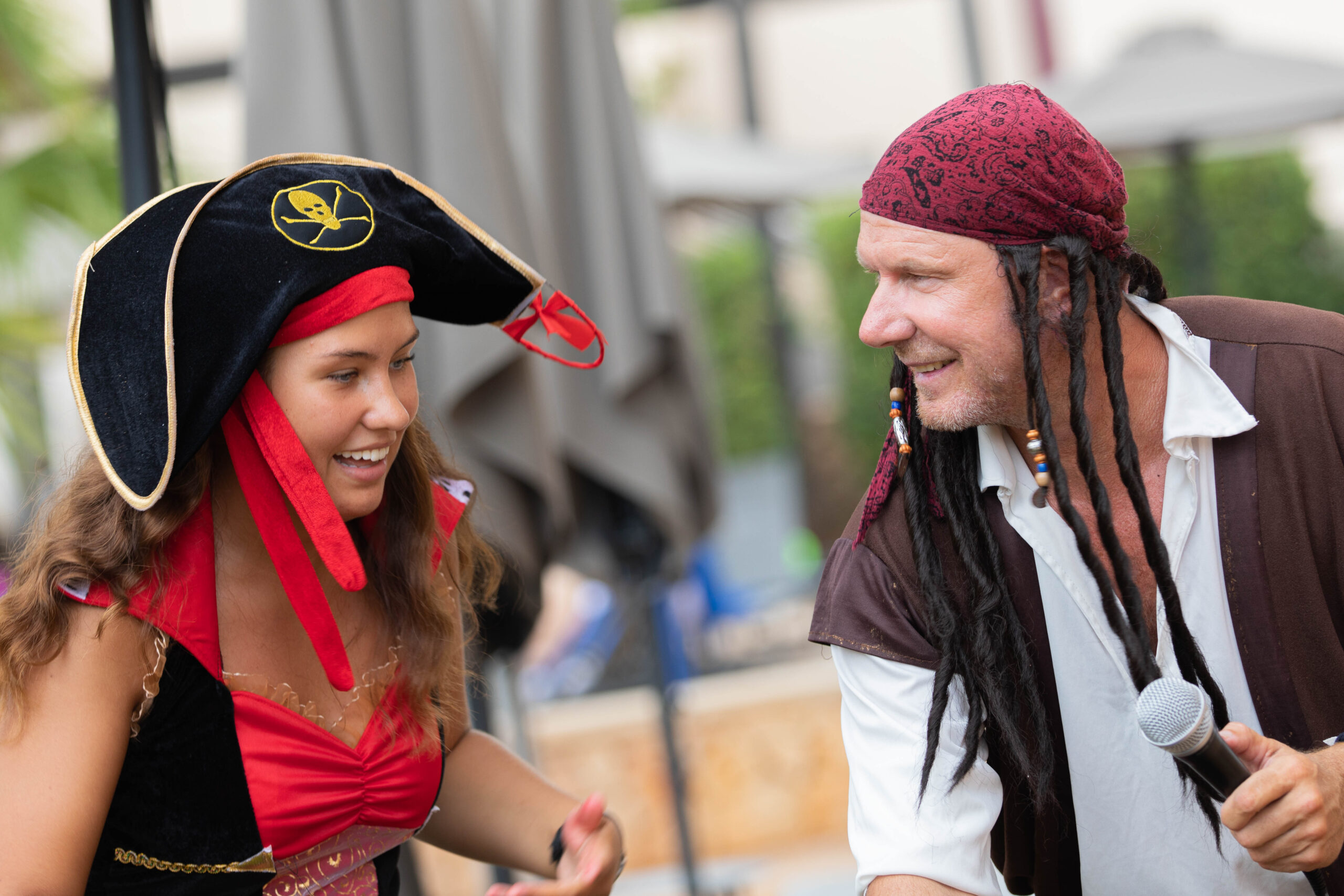 Two TUI entertainers dressed as pirates laughing and happy.